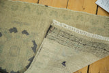 Vintage Turkish Oushak runner's hand-knotted back and beige pile, with white fringe.