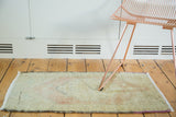 Hand knotted Oushak runner with faded celadon green, beige, and soft rust floral motifs.
