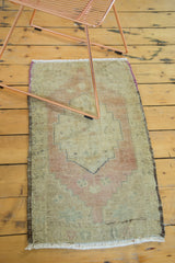 Vintage Oushak runner with faded beige and brick geometric pattern, showing secured edge.