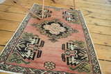 Vintage Oushak rug, expressive central medallion, short pile, blush and peach tones.