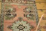 Close-up of vintage Oushak rug: peach field, powder blue medallion, and angular germinating planter motifs.