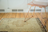 Vintage Oushak rug, ornate beige and light brown medallion with rams horn elements.