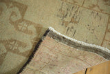 Vintage Oushak rug's secure dark charcoal edge, tight hand-knotted back, and white fringe.