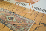 Vintage Turkish Oushak runner: stepped medallion, pinwheel, faded celadon and burnt brick red.