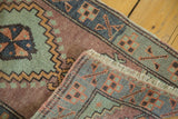Fringe and stepped geometric pattern in celadon green and muted red on the Oushak runner.