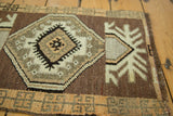 Chocolate brown field, ivory and sand oversized medallion with small motifs.