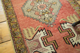 Vintage Oushak rug runner corner featuring germinating planter design, stepped patterns, and even wear.