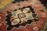 Geometric motif on vintage Oushak rug, with terracotta, dark brown, and coral pink accents.