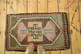 Vintage Oushak rug with central geometric medallion, finned plants, bronze, rose tones.