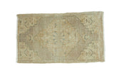 Distressed vintage Oushak runner, subtle medallion in faded beige, sand, and pale green.