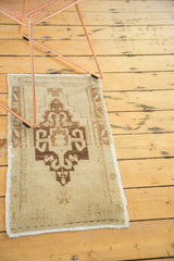 Hand-knotted vintage Oushak rug runner featuring a rectilinear medallion with ram horn motifs, beige and bronze.