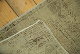 Hand-knotted vintage Oushak mat corner, with even distress, sand tones, and secured edges.