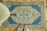 Hand knotted Oushak rug mat featuring aqua blue medallion and fish spandrels.
