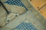 Hand knotted vintage Oushak rug's even short pile and secured woven edge detail.