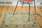 Vintage hand-knotted Oushak rug, minimalist geometric medallion and zigzag border, ivory, sand tones.