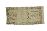 Vintage Oushak rug, elongated medallion, ivory, beige, charcoal brown geometric design.