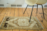 Dark chocolate and light bronze rams horn motif on the vintage Oushak runner.