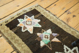 Thick plush pile of a vintage Oushak rug with mint green, blush star motifs, beige border.