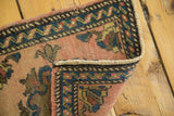 Secured fringe and geometric border on vintage Oushak rug, showing mostly even pile wear.