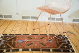 Vintage Oushak runner with burgundy copper field, serrated leaves, and mellow violet central motif. 1'6