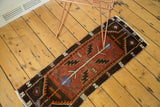 Serrated leaf and mellow violet flower motifs on the burgundy field of a vintage Oushak runner.