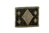 Mid-20th century Oushak rug with a dark charcoal background and silver, dusty blush diamond medallion.