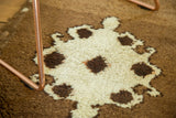 Thick plush pile on a vintage Oushak rug, showing ivory and chocolate village-type medallion.