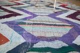 Dense hand-woven texture of the vintage Moroccan rag rug with colorful chevron design.