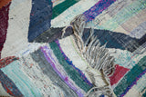 Detail of vintage Moroccan rag rug, highlighting varied multicolored cotton strips and fringe.