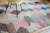 Dense, hand woven texture of vintage rag rug showing colorful diamond fills.