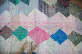 Dense, recycled cotton texture of this geometric vintage rag rug, with teal and charcoal diamond motifs.
