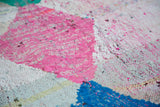 Textured weave of pink, ivory, and sky blue recycled cotton rag rug.