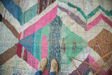 Colorful zigzag motif with textured recycled cotton textiles of a vintage rag rug.