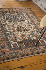 Vintage Hamadan rug fringe and border, showing apricot, indigo, and ivory palmette patterns.