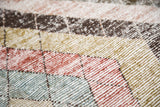 Distressed Baktiari carpet pile features cinnabar red, apple green, powder blue mosaic tiles.
