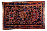 Vintage Persian Heriz rug, hand-knotted with triple medallions, geometric field, madder red, indigo blue, 3'9