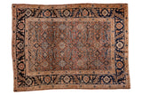 Antique Persian Tabriz rug with pale rust field, intricate Herati motif, and inky blue borders, 4'6