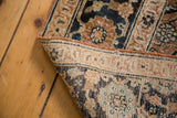 Close view of antique Tabriz rug corner, highlighting hand-knotted construction and secure rust edge.