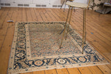 Antique Tabriz rug's lower right, featuring intricate Herati motif in pale rust, ivory, and blue.