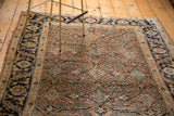 Intricate Herati motif of pale rust, ivory, and inky-charcoal blue on an antique Tabriz rug.