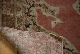 Hand-knotted backing and distressed rust salmon pile of an antique Tabriz rug.