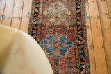 Distressed antique Heriz rug, pale madder red field with sky blue floral medallion.