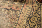Folded distressed Kaisary carpet highlighting earthen Herati field and turtle samovar border motif.