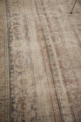 Distressed vintage Kaisary carpet detail highlighting threadbare texture and faded earthen patterns.