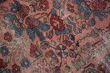 Heavy distressed pile texture with jewel rose, sapphire blue, and red floral motifs.