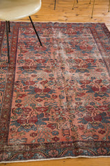Distressed antique Lilihan rug corner, showcasing jewel rose and sapphire floral motifs with even wear.