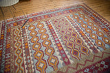Tribal Kilim rug's 'running water' motif in light blue, orange, and rich red tones.