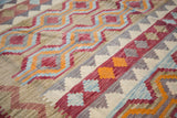 Flatweave Kilim pattern showing tribal water channels in burgundy, blue, orange, and cream.