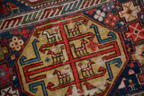 Geometric animal motifs on a distressed mustard yellow field of an antique Shirvan rug.