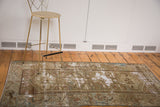 Distressed antique Persian Malayer rug with moss green, brown, and foundation showing through.